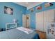 Well-lit blue bedroom with white trim, closet, and light wood flooring at 9724 Canyon Walk Ave, Las Vegas, NV 89147