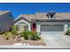 Charming single-story home featuring a well-maintained front yard and an attached two-car garage at 9724 Canyon Walk Ave, Las Vegas, NV 89147
