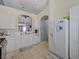 Well-appointed kitchen with stainless steel appliances, a refrigerator, and white cabinets at 9724 Canyon Walk Ave, Las Vegas, NV 89147