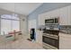 Bright kitchen with white cabinetry, tile flooring, and a cozy breakfast nook at 9724 Canyon Walk Ave, Las Vegas, NV 89147