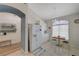 Eat-in kitchen featuring white cabinets, stainless refrigerator, and casual dining nook with natural light at 9724 Canyon Walk Ave, Las Vegas, NV 89147