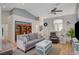 Comfortable living room showcasing neutral-toned furniture, ceiling fan, and open floor plan at 9724 Canyon Walk Ave, Las Vegas, NV 89147