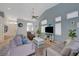 Bright living room with light blue walls, vaulted ceilings and contemporary decor at 9724 Canyon Walk Ave, Las Vegas, NV 89147