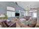 Spacious living room featuring a high ceiling, multiple windows, and comfortable seating arrangement at 9724 Canyon Walk Ave, Las Vegas, NV 89147