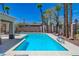 Refreshing swimming pool surrounded by palm trees and a spacious patio area at 9724 Canyon Walk Ave, Las Vegas, NV 89147