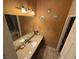 Bathroom vanity featuring double sinks, granite counters, decorative wall art and updated lighting fixtures at , North Las Vegas, NV 89031