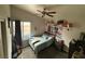 Cozy bedroom with ceiling fan, carpet, and large window for natural light at , North Las Vegas, NV 89031