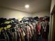 Walk-in closet with multiple racks for hanging clothes, lit by a central ceiling light at , North Las Vegas, NV 89031