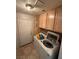 Efficient laundry room with upper cabinets and modern washing machine at , North Las Vegas, NV 89031