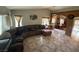 Open-concept living room with tile flooring, high ceilings, large sofa, and arched entryways at , North Las Vegas, NV 89031