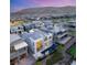 Aerial view of a modern home with a backyard pool, set against a backdrop of desert landscapes and mountains at 10752 Patina Hills Ct, Las Vegas, NV 89135