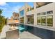 Luxurious backyard with a pool, fire pit, modern architecture, and desert landscaping for an upscale outdoor living at 10752 Patina Hills Ct, Las Vegas, NV 89135