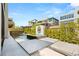 Modern backyard with a pool, lounge chairs, lush landscaping, and stylish outdoor space at 10752 Patina Hills Ct, Las Vegas, NV 89135