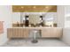 Sleek bathroom featuring a double vanity, stylish mirror, ample counter space, and modern wood cabinetry at 10752 Patina Hills Ct, Las Vegas, NV 89135