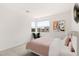 Cozy bedroom with a large window, comfortable bed, and tasteful decor at 10752 Patina Hills Ct, Las Vegas, NV 89135