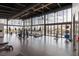 A well-equipped fitness center with treadmills, weights, and large windows offering scenic views at 10752 Patina Hills Ct, Las Vegas, NV 89135