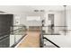 Bright hallway with glass railings overlooking the lower level, showcasing an open floor plan and stylish decor at 10752 Patina Hills Ct, Las Vegas, NV 89135