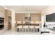 Modern kitchen with light wood cabinetry, stainless steel appliances, and a center island with counter seating at 10752 Patina Hills Ct, Las Vegas, NV 89135
