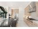 Modern kitchen with stainless steel appliances, light wood cabinetry, and island with sink at 10752 Patina Hills Ct, Las Vegas, NV 89135