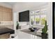 Bright living space featuring modern gas fireplace, light wood cabinetry, and a comfy sofa with a view at 10752 Patina Hills Ct, Las Vegas, NV 89135