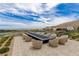 Inviting patio featuring a modern fire pit and comfortable seating, perfect for outdoor relaxation at 10752 Patina Hills Ct, Las Vegas, NV 89135