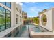 Backyard featuring a stunning pool, water feature, and modern architectural design, ideal for relaxation and entertainment at 10752 Patina Hills Ct, Las Vegas, NV 89135