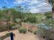 This backyard view overlooks a golf course, pool, lush greenery, and desert landscaping at 1091 Casa Palermo Cir, Henderson, NV 89011