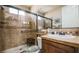 Bathroom featuring a large glass shower enclosure, vanity with sink, and tiled walls at 1091 Casa Palermo Cir, Henderson, NV 89011