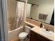 Bathroom featuring shower over tub with a white shower curtain, a sink and vanity at 1091 Casa Palermo Cir, Henderson, NV 89011