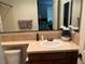 Bathroom with tile countertops, sink, toilet, large mirror, and towels on a rack at 1091 Casa Palermo Cir, Henderson, NV 89011