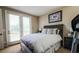 Cozy bedroom with outdoor access via french doors, allowing for fresh air and light at 1091 Casa Palermo Cir, Henderson, NV 89011