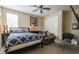 Cozy bedroom featuring a plush bed, ceiling fan, and a comfortable seating area for relaxation and leisure at 1091 Casa Palermo Cir, Henderson, NV 89011