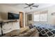 Comfortable bedroom featuring a bed, couch, ceiling fan and TV at 1091 Casa Palermo Cir, Henderson, NV 89011