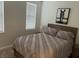 Cozy bedroom with a bed, artwork, window, and bedside table with lamp at 1091 Casa Palermo Cir, Henderson, NV 89011