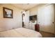 Carpeted bedroom with walk-in closet and a modern television set for entertainment at 1091 Casa Palermo Cir, Henderson, NV 89011