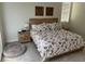Bright bedroom features a cozy bed with floral bedding, wooden nightstands, and natural light at 1091 Casa Palermo Cir, Henderson, NV 89011