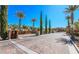 Community entrance with guard gate, desert landscaping, and decorative brick paver street at 1091 Casa Palermo Cir, Henderson, NV 89011