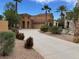 Elegant home featuring a long driveway, desert landscaping, and a charming stucco exterior at 1091 Casa Palermo Cir, Henderson, NV 89011