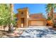 Two-story home with stone accents, covered entry, and a two-car garage on a sunny day at 1091 Casa Palermo Cir, Henderson, NV 89011