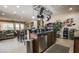 Bright open kitchen features a large center island, stainless steel appliances, and pot rack above at 1091 Casa Palermo Cir, Henderson, NV 89011