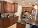 Well-equipped kitchen featuring granite countertops, stainless steel appliances, and wood cabinetry at 1091 Casa Palermo Cir, Henderson, NV 89011