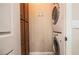 Functional laundry room with stacked washer and dryer units, along with ample storage in the built-in cabinets at 1091 Casa Palermo Cir, Henderson, NV 89011
