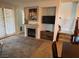 Open living room with fireplace, TV, and access to dining area and backyard at 1091 Casa Palermo Cir, Henderson, NV 89011
