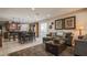 Open-concept living space with a comfortable sofa, adjacent to a dining area and kitchen at 1091 Casa Palermo Cir, Henderson, NV 89011