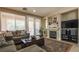 Cozy living room with a fireplace, comfortable seating, and a sliding glass door at 1091 Casa Palermo Cir, Henderson, NV 89011