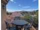 Outdoor dining set on a patio with scenic views of mountains and neighborhood at 1091 Casa Palermo Cir, Henderson, NV 89011