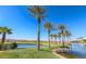 Community pond and greenbelt area with palm trees and mature desert landscaping at 1091 Casa Palermo Cir, Henderson, NV 89011