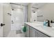 A bathroom featuring a shower and tub, light grey cabinets, and white countertops at 10933 Sageview Ave, Las Vegas, NV 89166