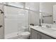Modern bathroom features tiled shower with glass door and gray vanity with solid surface countertop at 10933 Sageview Ave, Las Vegas, NV 89166