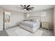 Spacious bedroom with a ceiling fan, carpeted floor, and multiple windows at 10933 Sageview Ave, Las Vegas, NV 89166